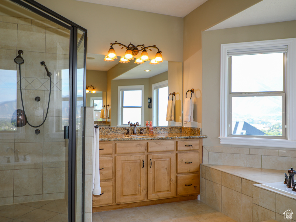 Bathroom with independent shower and bath, vanity, and tile patterned floors