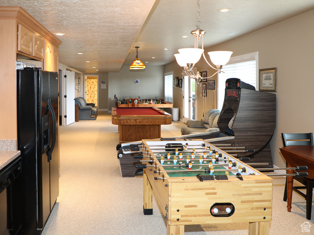 Rec room featuring light colored carpet, a notable chandelier, a textured ceiling, and billiards