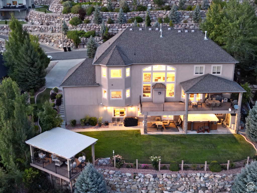 Back of property with a patio, an outdoor hangout area, a gazebo, and a yard