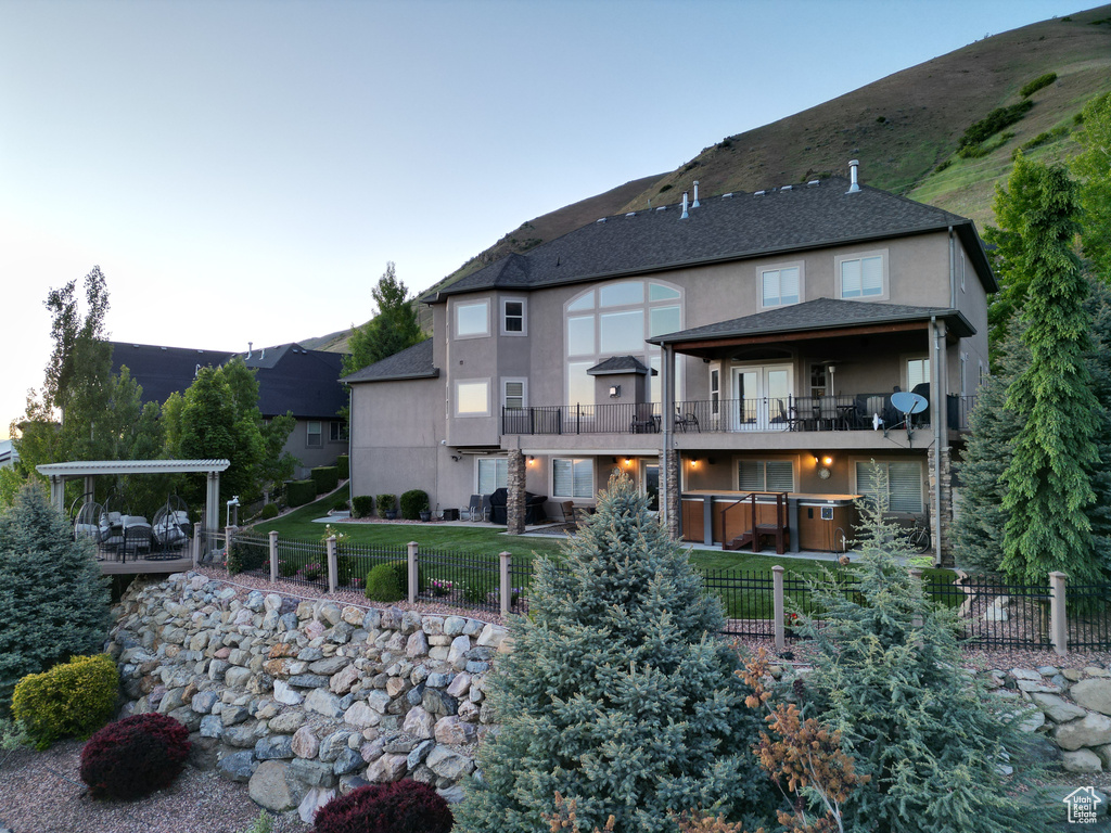 Back of house featuring a balcony