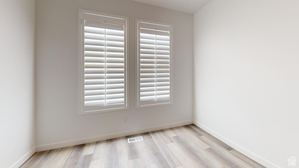 Unfurnished room featuring plenty of natural light and light hardwood / wood-style floors