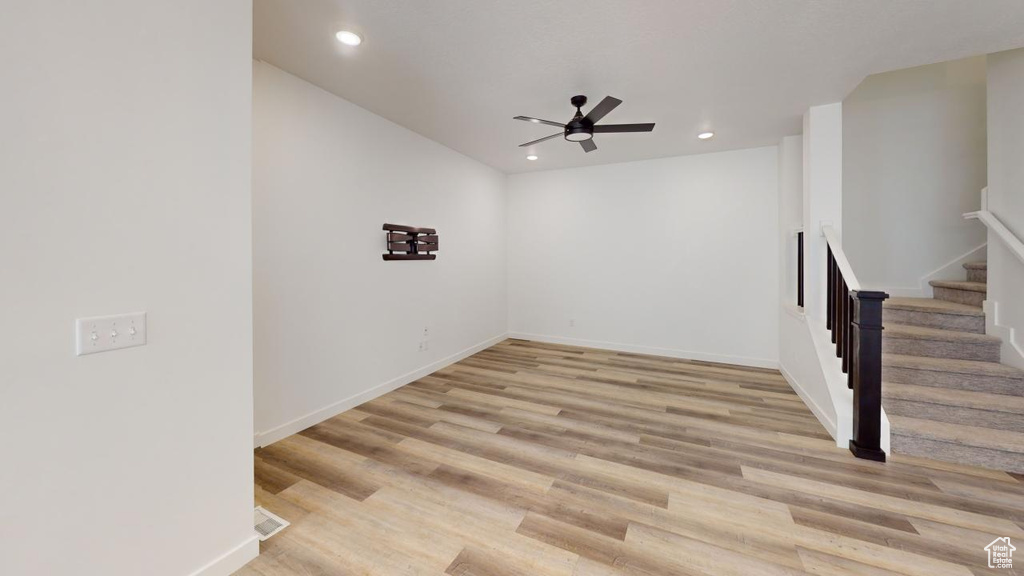 Spare room with ceiling fan and light hardwood / wood-style floors