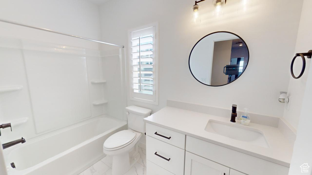 Full bathroom with vanity, toilet, shower / bathtub combination, and tile patterned floors