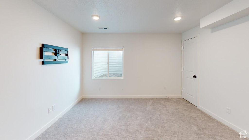 Spare room with light colored carpet