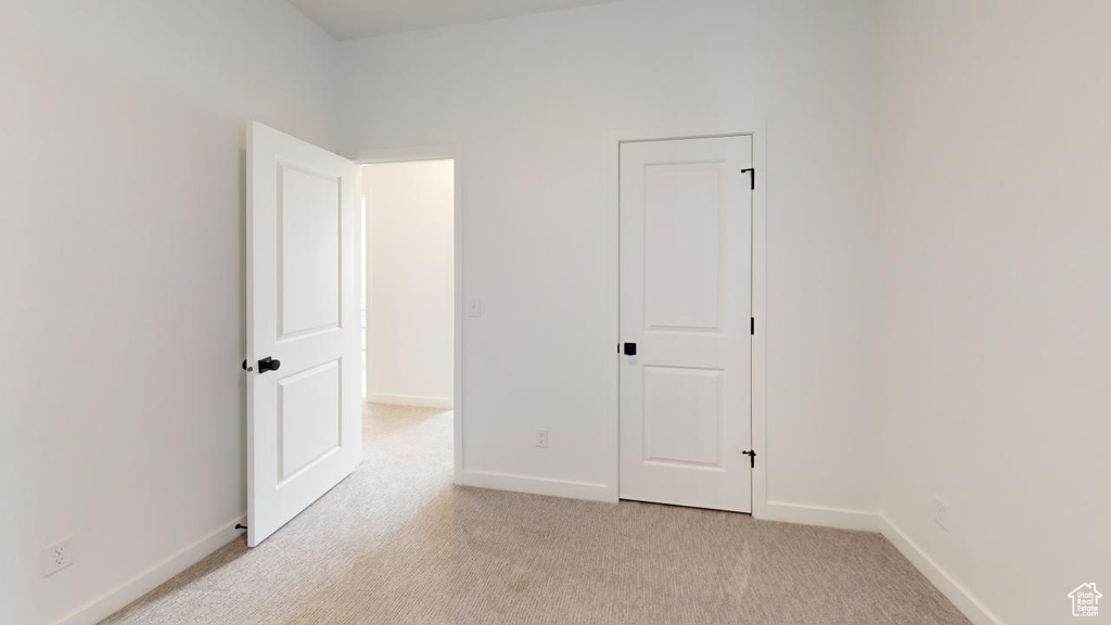 Spare room with light colored carpet