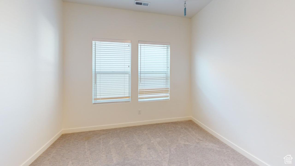 Unfurnished room with light colored carpet