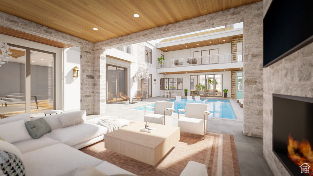 Interior space featuring outdoor lounge area, a balcony, and an indoor pool