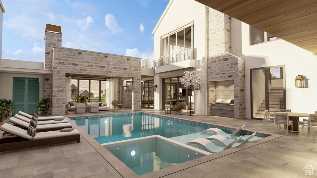 View of swimming pool with exterior kitchen, an outdoor living space, and a patio area