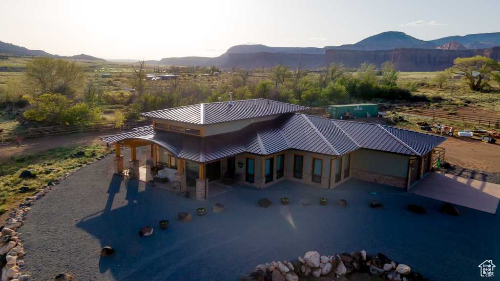 View of front of home with a mountain view, a standing seam roof, and metal roof