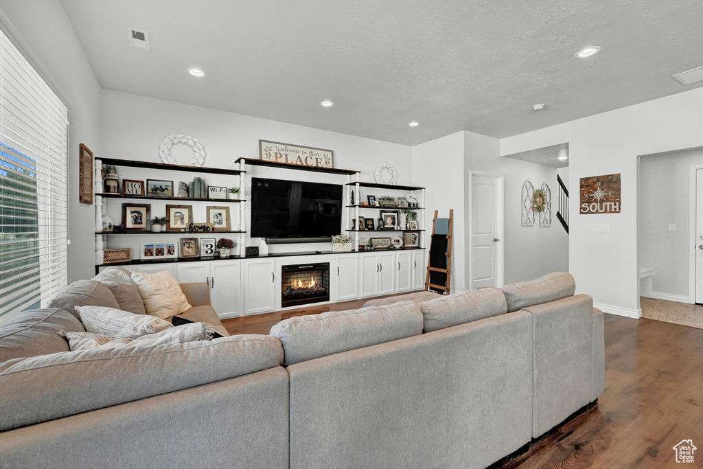 Living room with dark hardwood / wood-style flooring