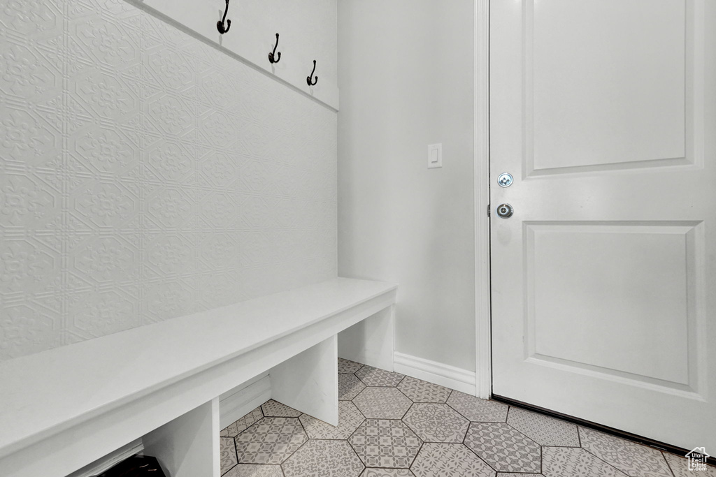 Mudroom with light tile patterned floors