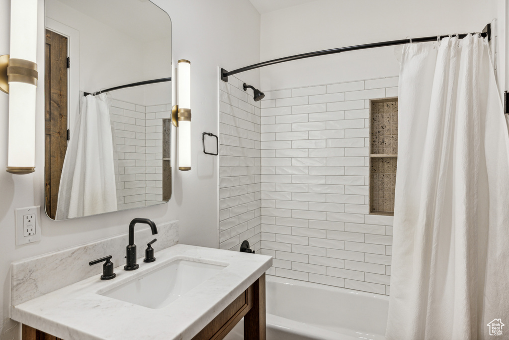 Bathroom featuring vanity and shower / bath combo with shower curtain