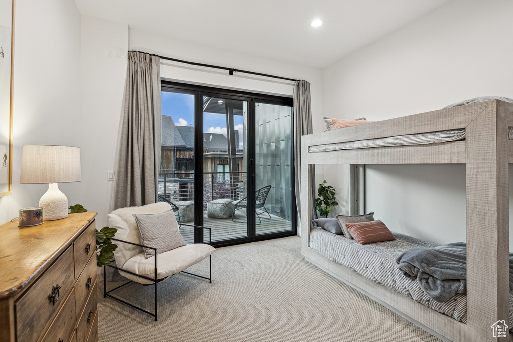 Bedroom featuring light carpet and access to outside