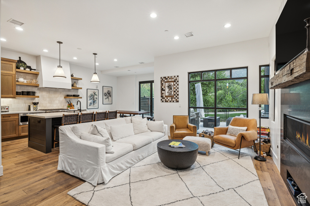 Living room featuring light wood-type flooring and sink