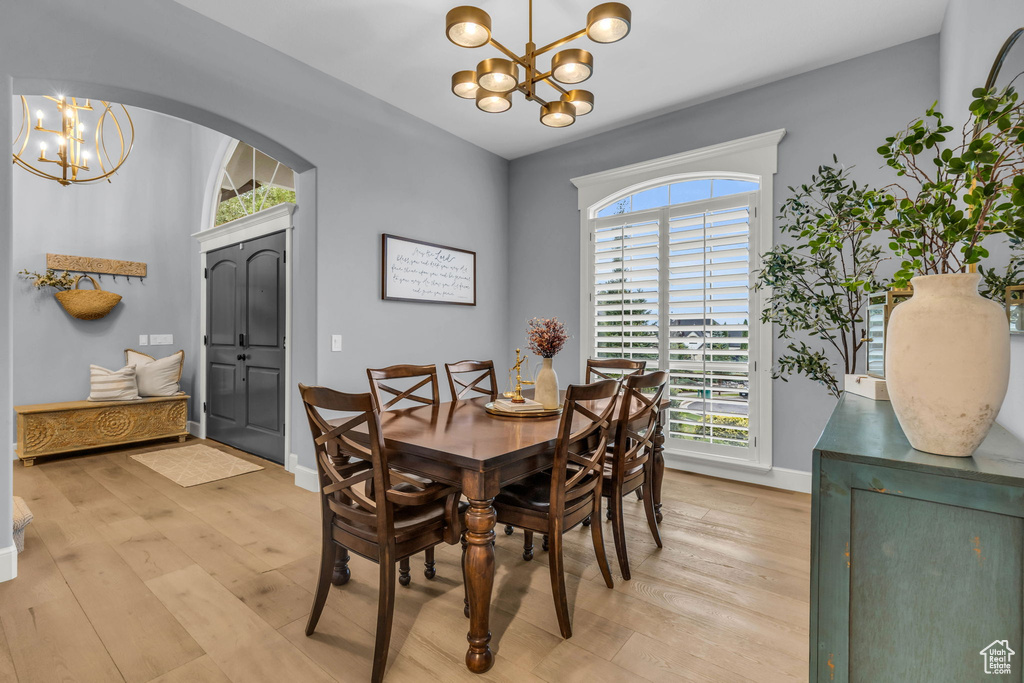 Dining area featuring light hardwood / wood-style flooring, a chandelier, and plenty of natural light