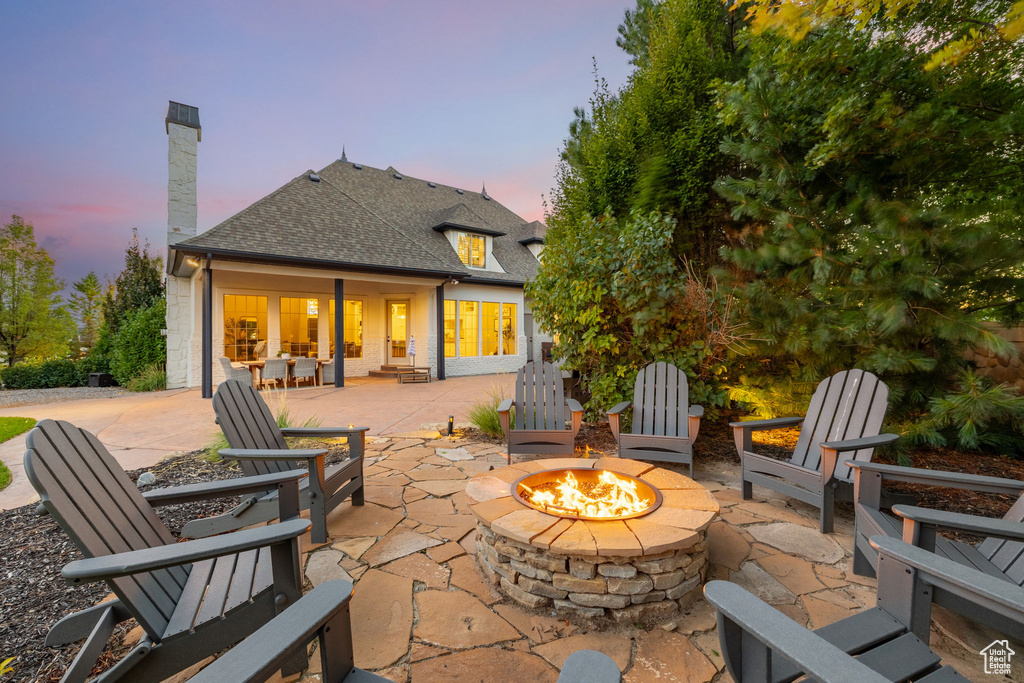 Patio terrace at dusk with an outdoor fire pit