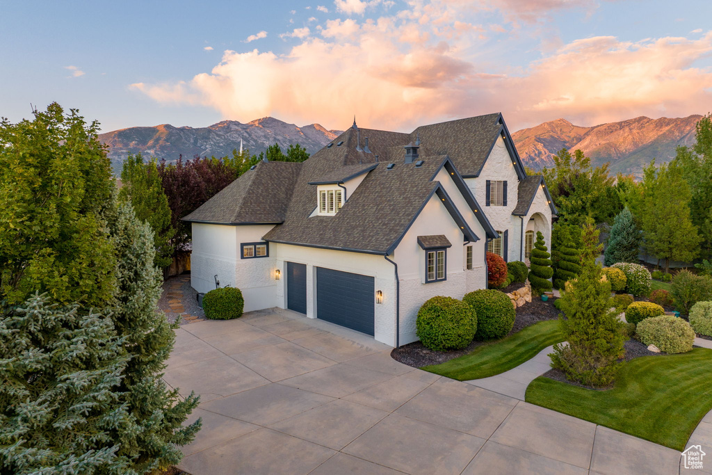 View of front facade featuring a garage and a mountain view