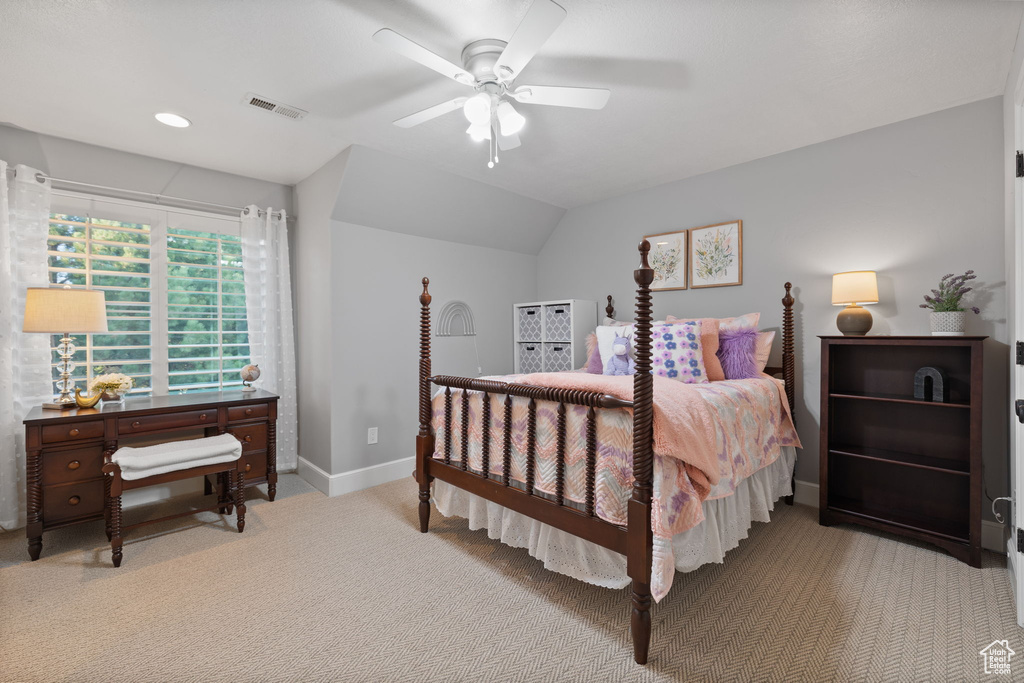 Bedroom with vaulted ceiling, ceiling fan, and light colored carpet