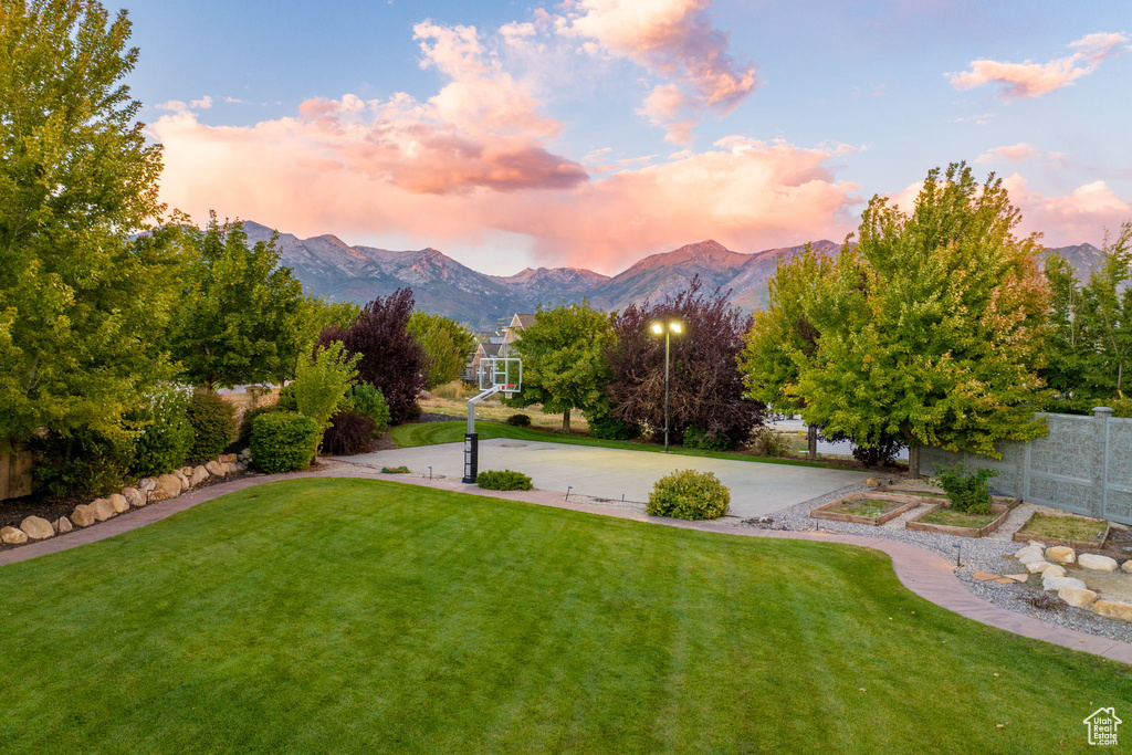 Yard at dusk featuring a mountain view