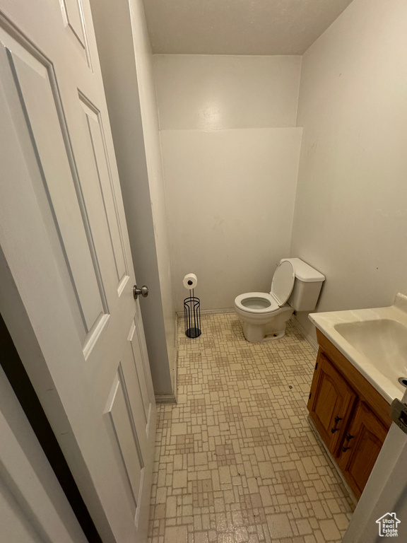 Bathroom featuring vanity, toilet, and tile patterned floors