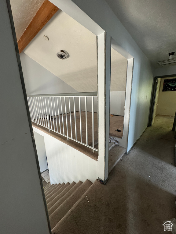 Staircase featuring beam ceiling