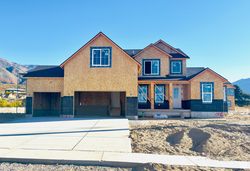 View of front of house with a mountain view and a carport