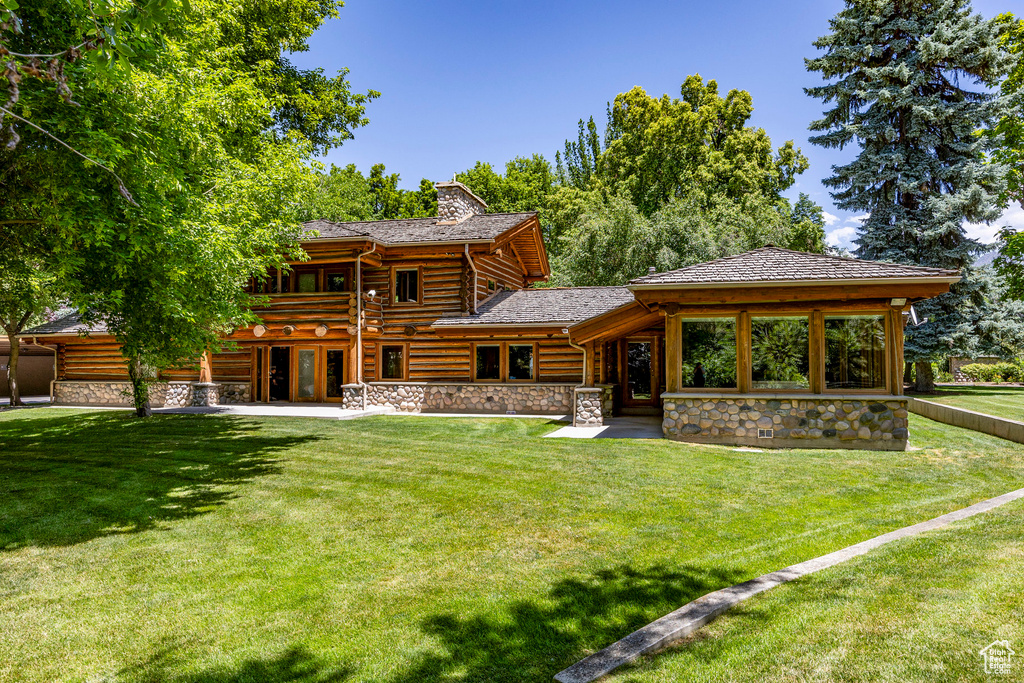 Back of house featuring a lawn