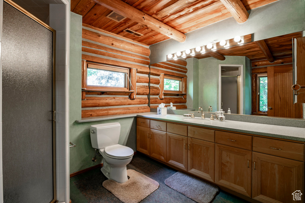 Bathroom featuring log walls, a shower with shower door, beamed ceiling, and wood ceiling