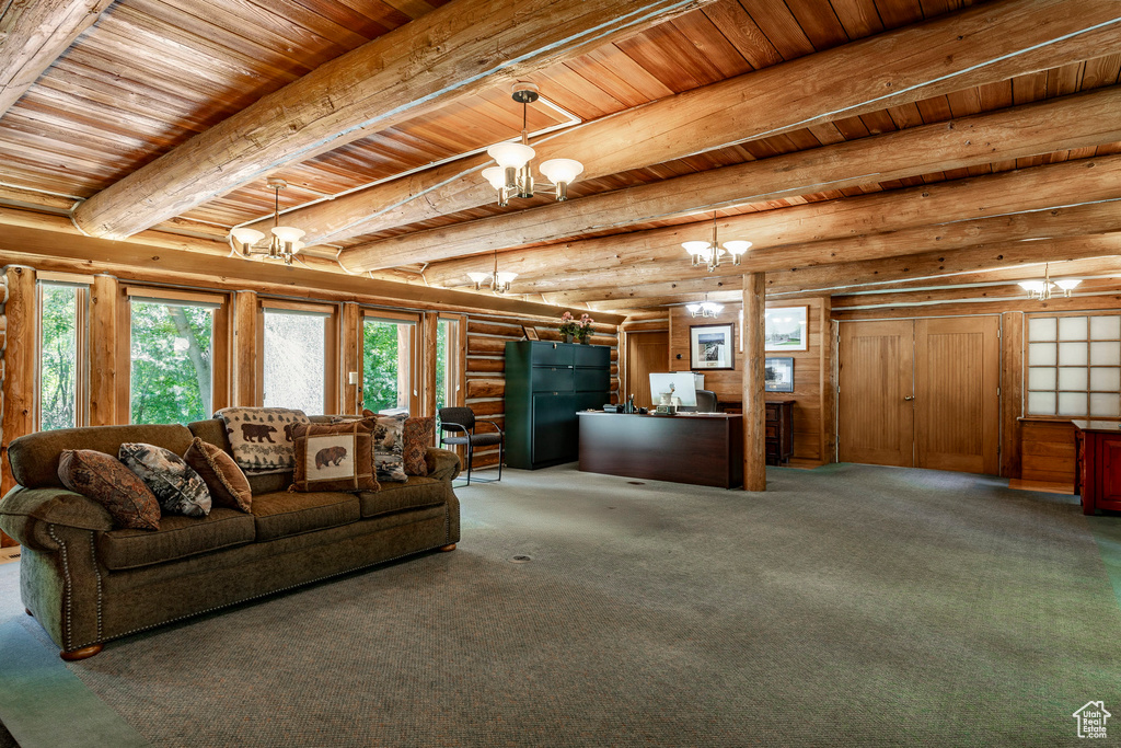 Living room featuring an inviting chandelier, wooden ceiling, carpet floors, beam ceiling, and rustic walls