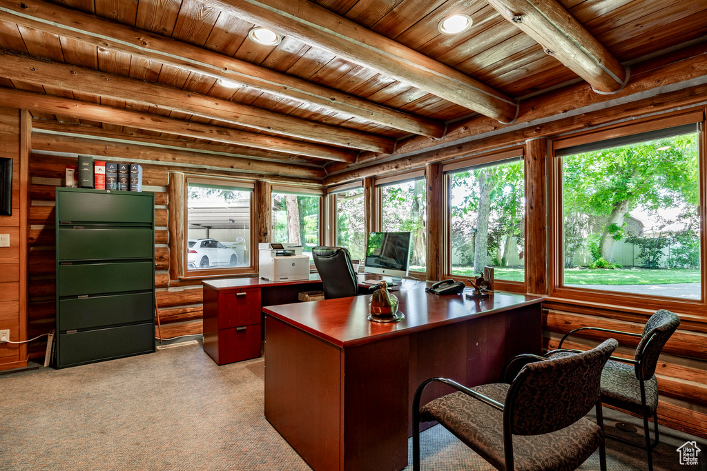 Carpeted home office with wood ceiling, log walls, and beam ceiling