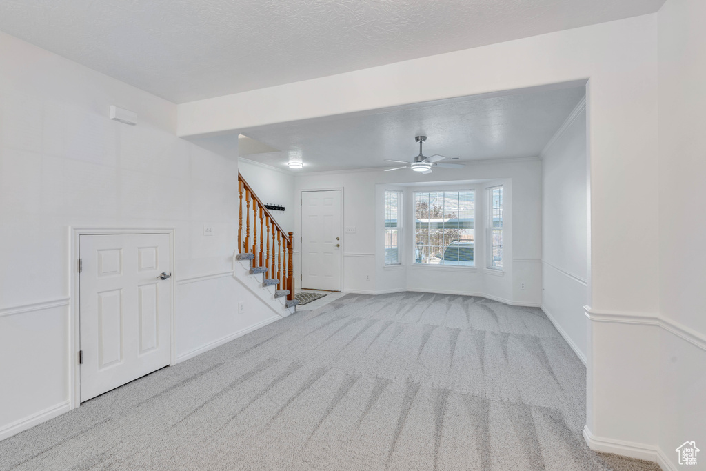 Carpeted empty room featuring ceiling fan