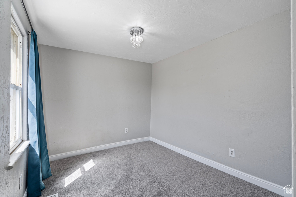 Spare room featuring carpet flooring