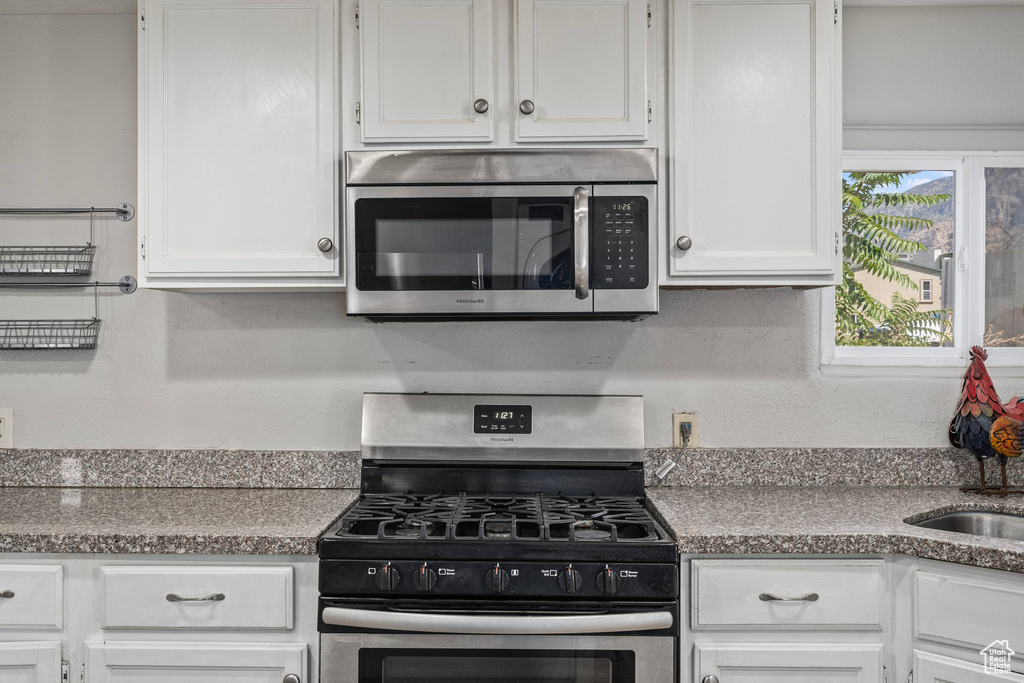 Kitchen featuring white cabinets and stainless steel appliances