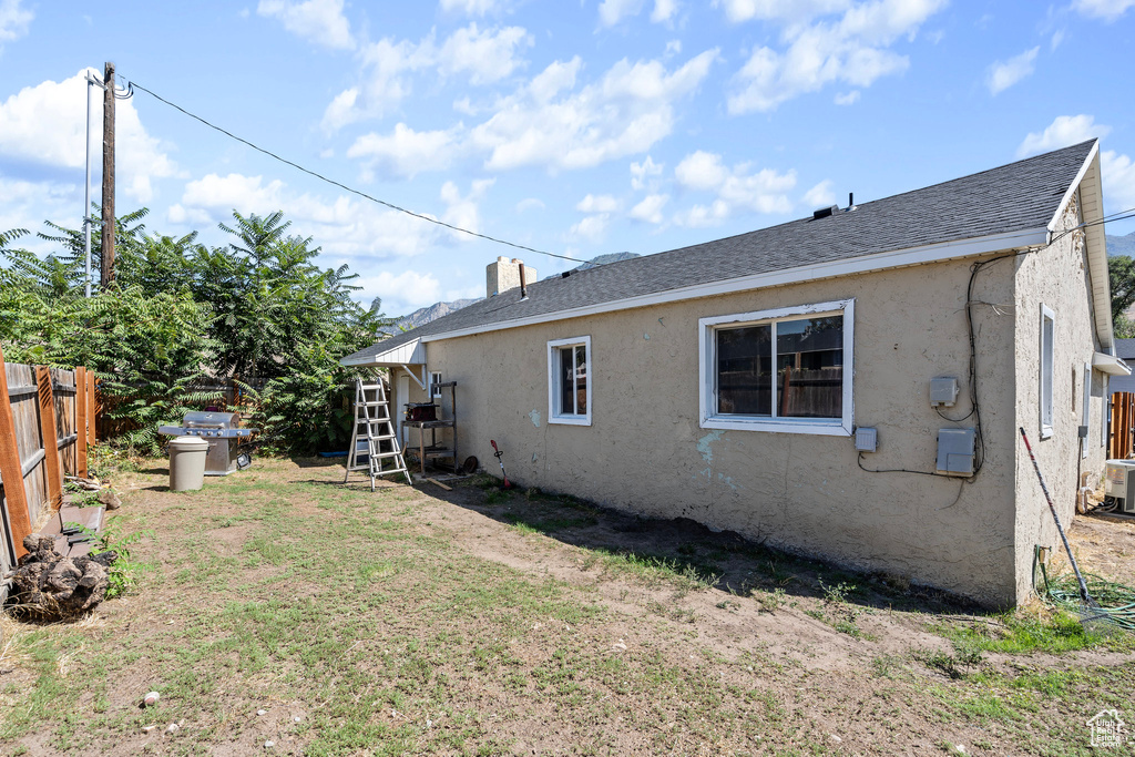 Rear view of property with central AC