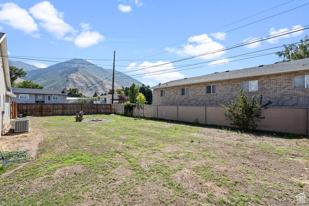 View of yard featuring a mountain view and central AC