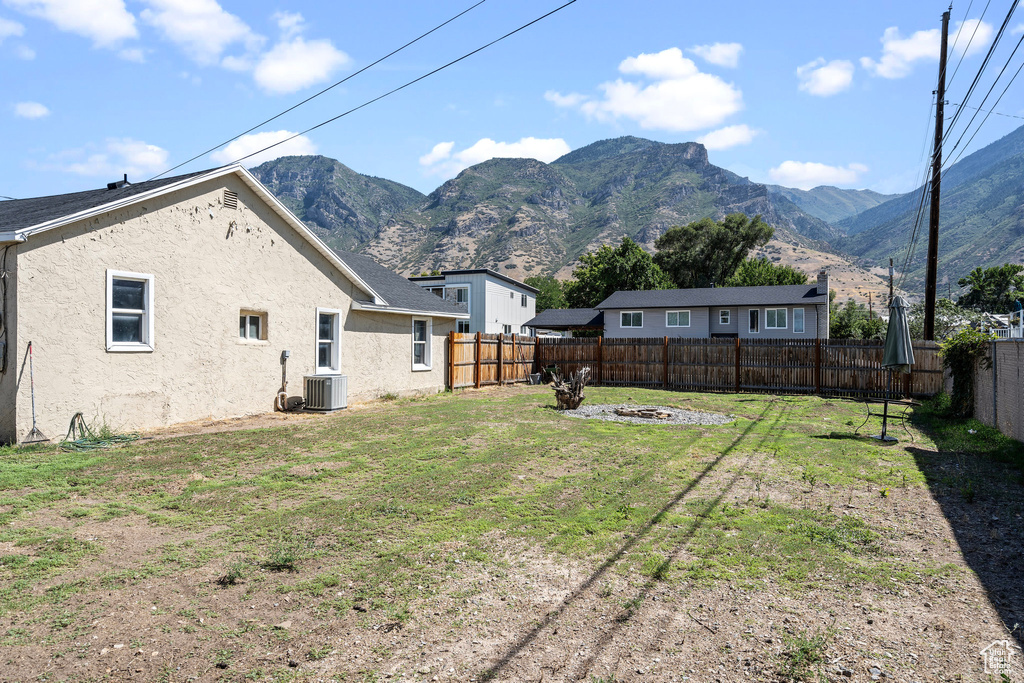 View of yard featuring a mountain view and central air condition unit