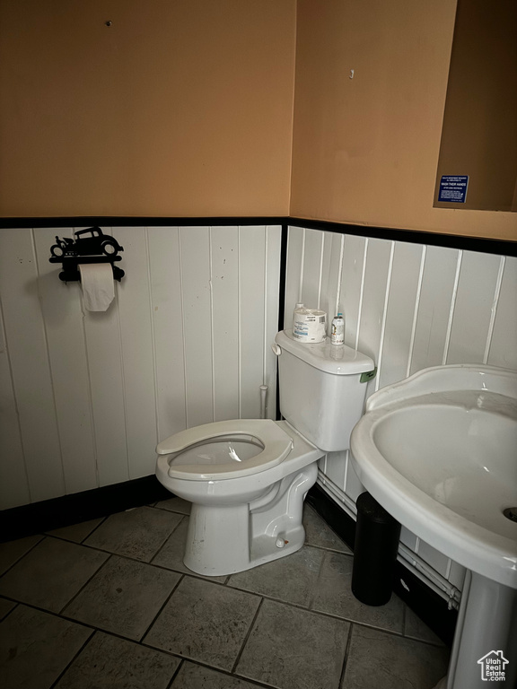 Bathroom featuring toilet and tile patterned floors