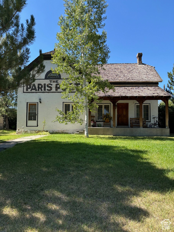 Rear view of house featuring a yard