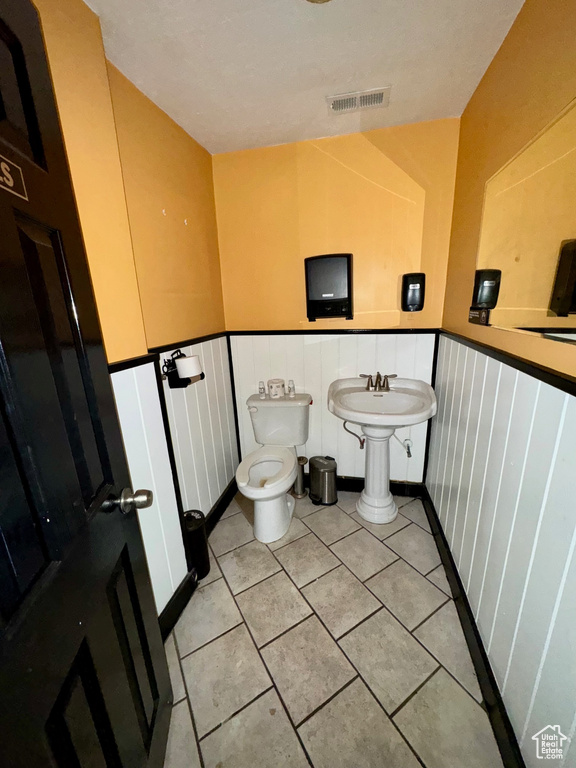 Bathroom with tile patterned flooring and toilet