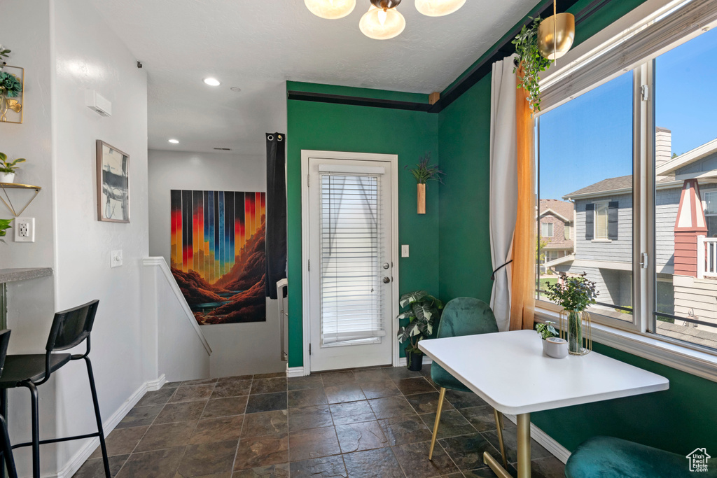 Foyer entrance with plenty of natural light and dark tile patterned floors