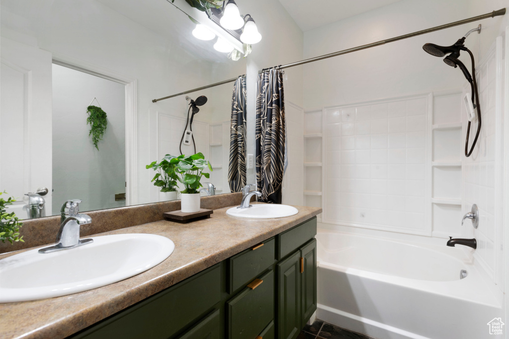 Bathroom featuring vanity, shower / bath combo with shower curtain, and tile patterned floors