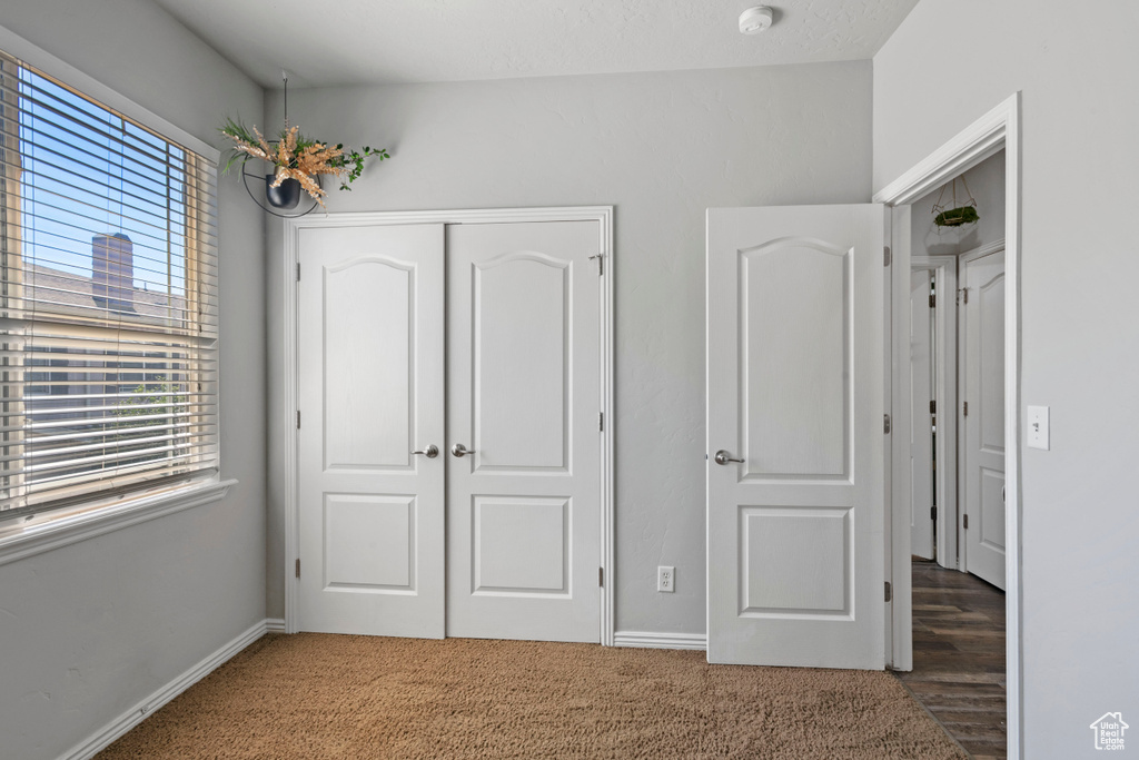 Unfurnished bedroom featuring a closet and carpet floors