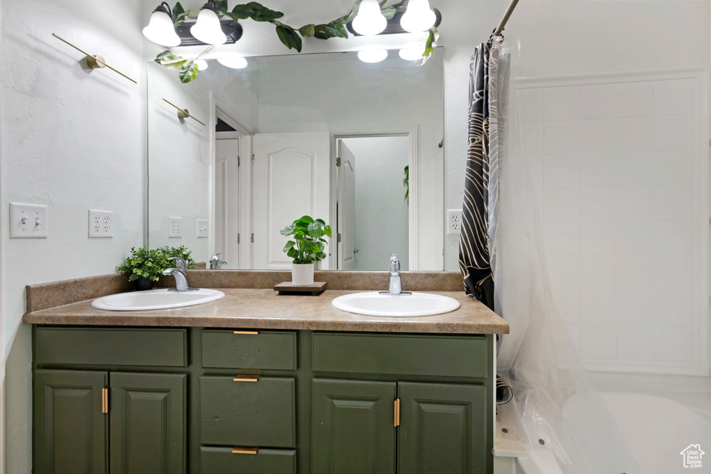 Bathroom featuring vanity and shower / bath combo with shower curtain