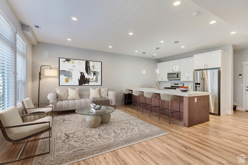 Living room with light hardwood / wood-style floors