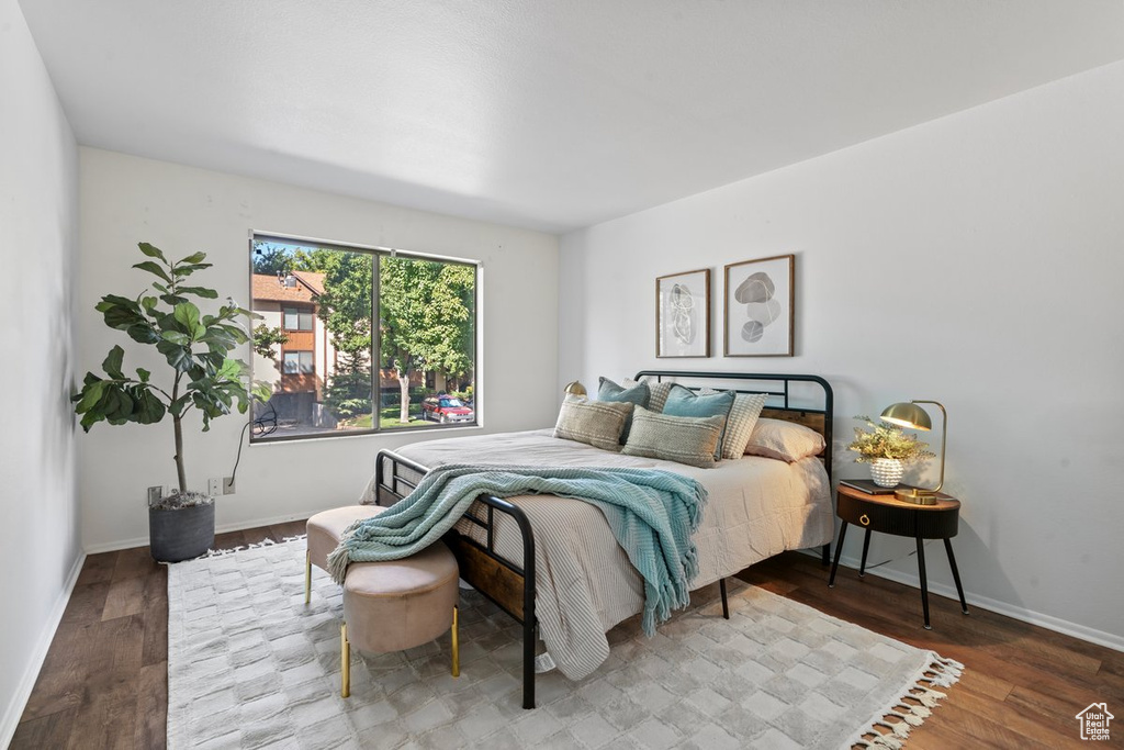 Bedroom with hardwood / wood-style flooring