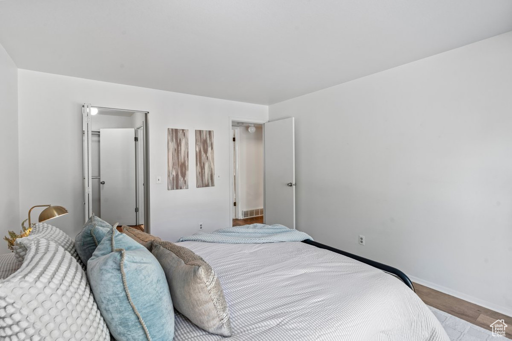 Bedroom with hardwood / wood-style floors