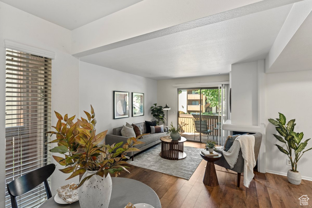 Living room featuring dark wood-type flooring and a textured ceiling