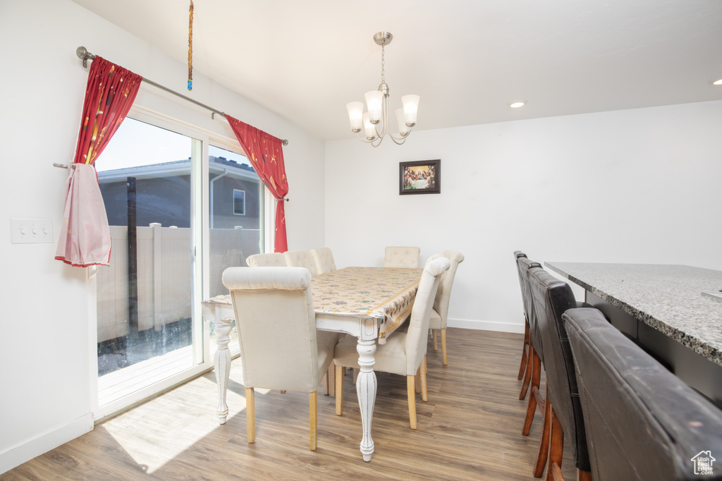 Dining room featuring hardwood / wood-style flooring and a notable chandelier