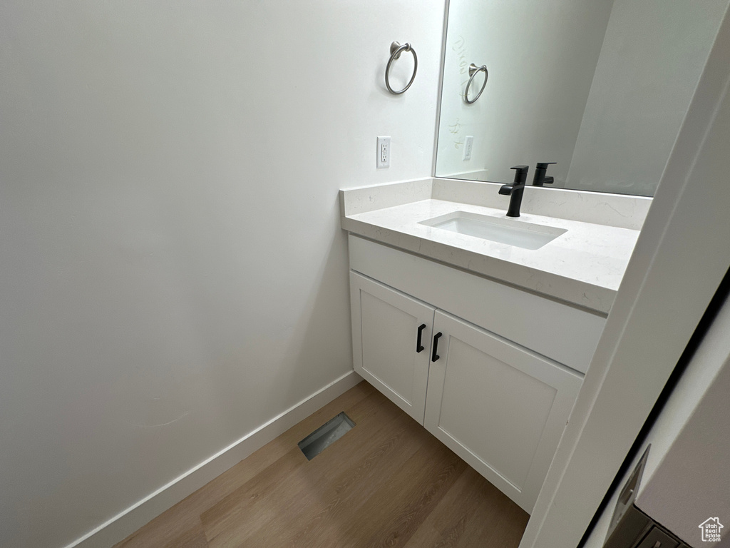 Bathroom featuring vanity and hardwood / wood-style flooring