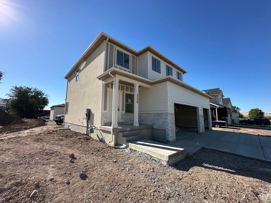 View of front of home featuring a garage and covered porch